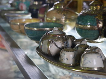 Close-up of antique crockery on table