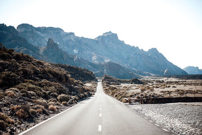 Road amidst mountains against sky