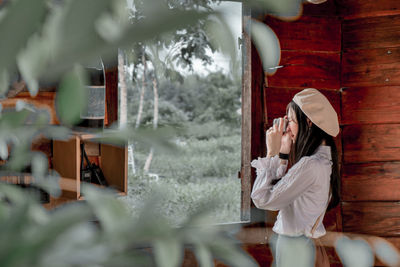 Side view of woman holding umbrella