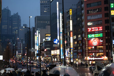 Illuminated city street and buildings at night