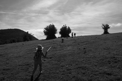 Man standing on field against sky