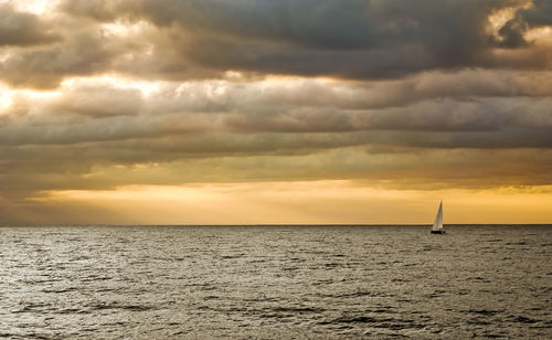 Scenic view of sea against dramatic sky