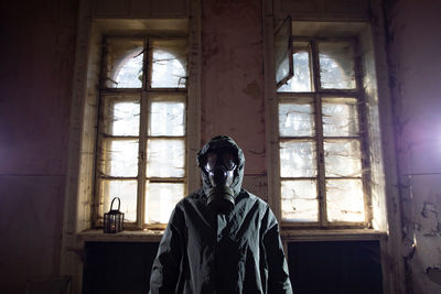 Portrait of woman standing in abandoned building