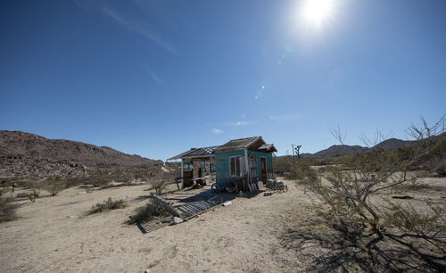 Built structure on land by houses against sky