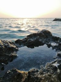 Scenic view of sea against sky at sunset