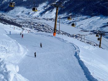 High angle view of people skiing on snowcapped mountain