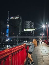 Illuminated buildings in city against sky at night