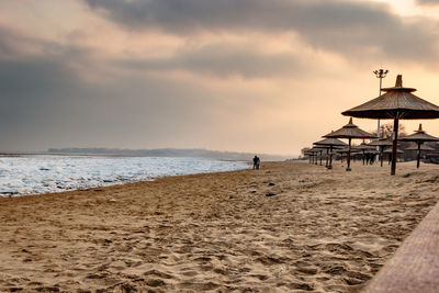 Scenic view of beach against sky during sunset