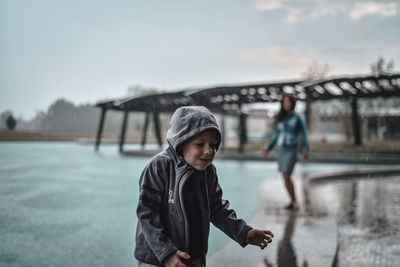 Mother with son in rain during rainy season