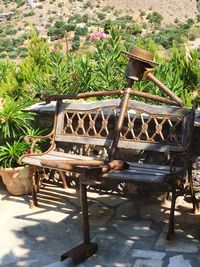 Empty chairs and table in yard