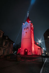 Low angle view of illuminated building against sky at night