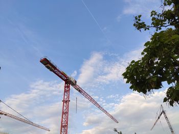 Low angle view of crane against sky