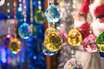 Close-up of christmas decoration hanging on glass for sale