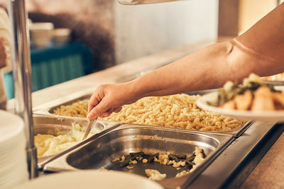 Cropped hand of man preparing food