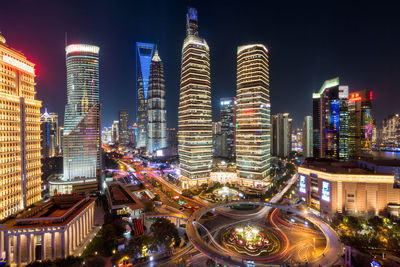 High angle view of illuminated buildings against sky at night