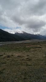 Scenic view of mountains against cloudy sky