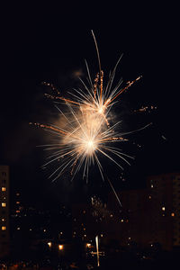 Low angle view of firework display at night