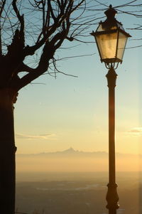 Low angle view of street light against sky during sunset