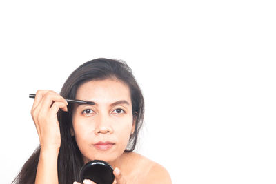 Portrait of a beautiful young woman over white background