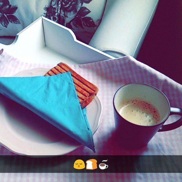 indoors, coffee cup, table, food and drink, drink, cup, still life, coffee, coffee - drink, refreshment, plate, saucer, tea cup, high angle view, book, tablecloth, close-up, freshness, spoon, no people