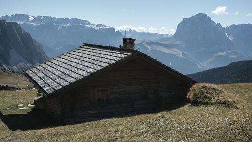 Scenic view of house and mountains against sky