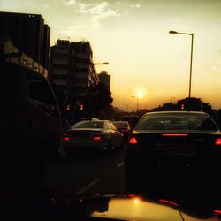 Cars on road at sunset