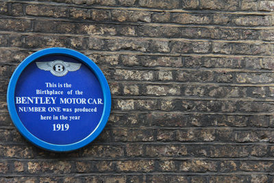 Close-up of information sign on wall