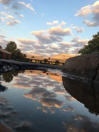 Scenic view of river against sky at sunset