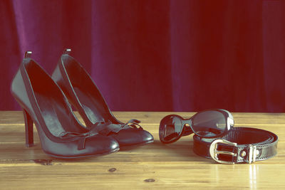 Close-up of shoes on wooden table