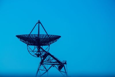 Low angle view of satellite dish against clear blue sky