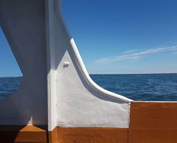 Sailboat on sea against blue sky