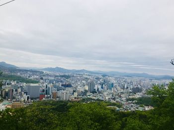 High angle view of buildings and trees against sky