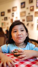 Portrait of cute girl sitting at home