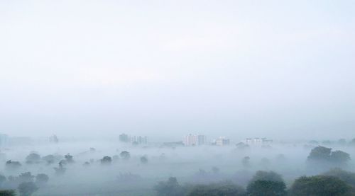 Panoramic view of city in foggy weather