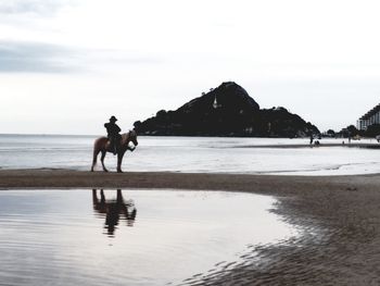 Man on beach against sky