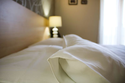 Close-up of white blanket on bed at home