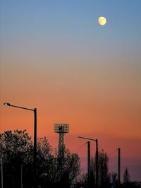 Low angle view of basketball hoop against sky during sunset