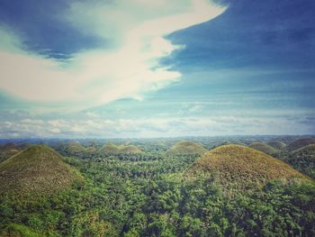 Scenic view of landscape against cloudy sky