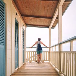 Full length of woman standing by railing