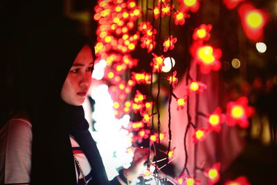 Portrait of woman looking away at night