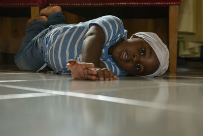 Portrait of boy lying on floor