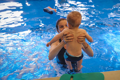 High angle view of boy swimming in pool