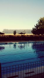 Swimming pool against clear blue sky