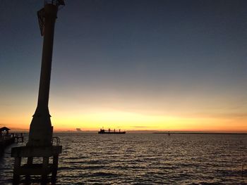 Scenic view of sea against dramatic sky during sunset