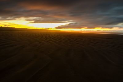 Scenic view of land against sky during sunset