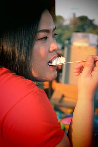 Close-up portrait of woman eating food