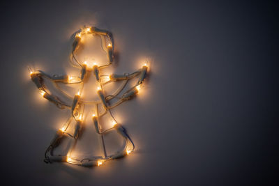 A glowing christmas angel with light bulbs. decoration on the window for the new year.