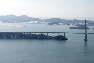 Bridge over sea against sky