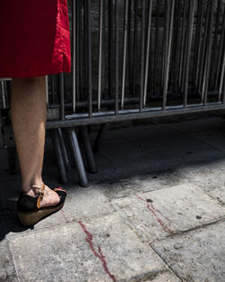 Low section of person standing on footpath