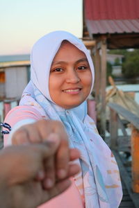 Portrait of smiling woman standing outdoors